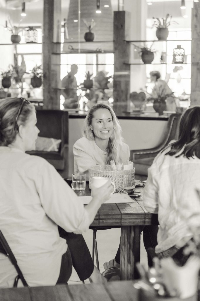 women sitting and smiling at networking event in Mallorca