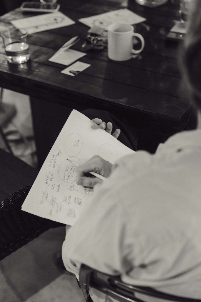 a woman sketching at an networking event