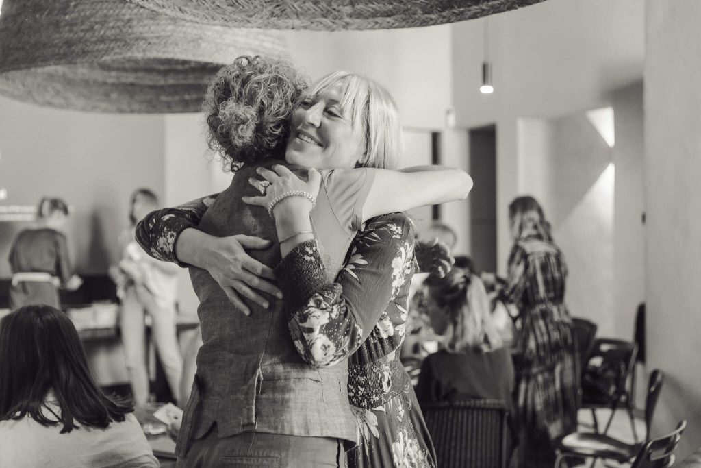 two women giving eachother a hug at a networking event in Mallorca